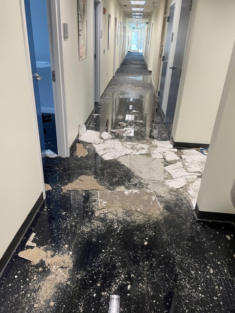 destroyed pieces of infrastructure on floor of a hallway