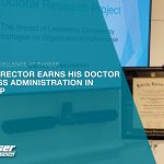 Picture of Wes Hershelman, Director of Finance at Sasser Restoration, holding his diploma.