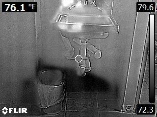 Infrared image of moisture behind a wall under a sink